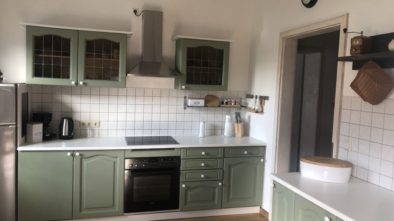 Küche mit E-Herd, Kühlgefrierschrank, Wasserkocher, Toaster, Kaffeemaschine und Esstisch für 3 Personen Küche mit E-Herd, Kühlgefrierschrank, Wasserkocher, Toaster, Kaffeemaschine und Esstisch für 3 Personen